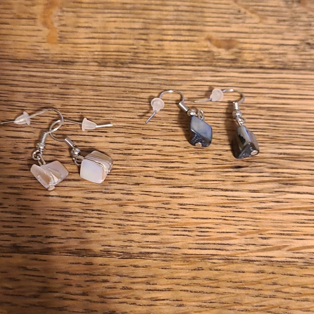 Two sets of dangle earrings